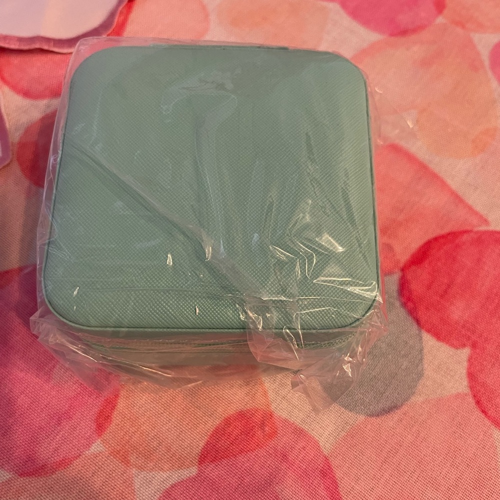 New in the box, light teal jewelry box. Great for travel